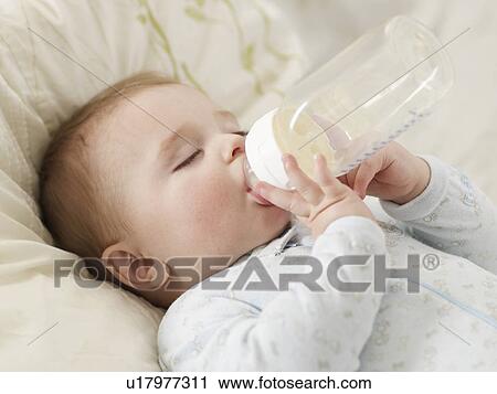 Baby Boy Sucking Milk Bottle View Large Photo Image Stock Image - Baby Boy Sucking Milk Bottle. Fotosearch