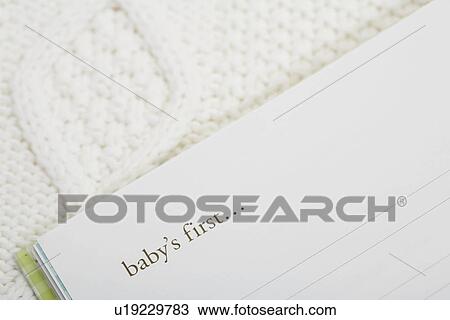 Stock Image - Baby memory book (close-up). Fotosearch