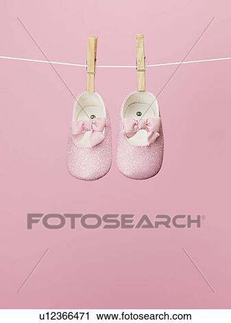 Stock Image - Baby Shoes on Clothes Line. Fotosearch