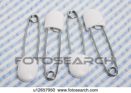 Stock Image - Four napkin pins. Fotosearch
