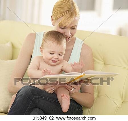 Stock Image - Mother and Baby Boy Looking at Picture Book. Fotosearch
