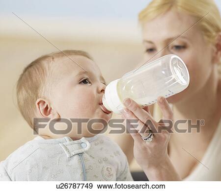 Stock Photo - Mother Feeding Baby Boy. Fotosearch