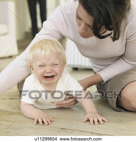 Mother with crying baby boy (0-6 months) View Large Photo Image Picture - Mother with crying baby boy (0-6 months). Fotosearch