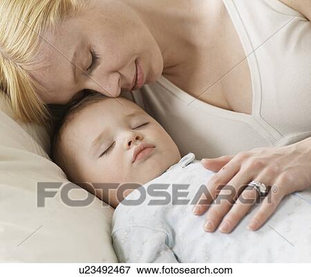 Stock Photo - Mother with Sleeping Baby Boy. Fotosearch