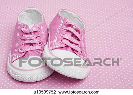 Stock Image - Pink baby sneakers. Fotosearch