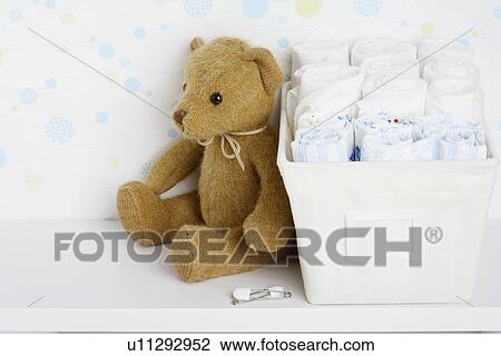 Teddy bear beside cloth diapers View Large Photo Image Stock Image - Teddy bear beside cloth diapers. Fotosearch