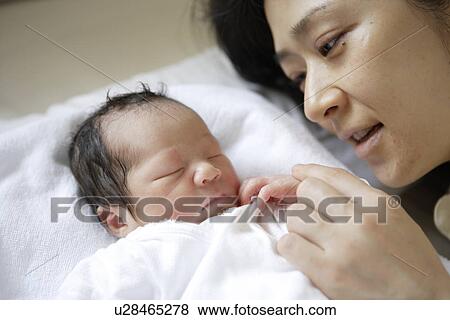 Stock Photo - The Baby And Mother Who Sleep. Fotosearch