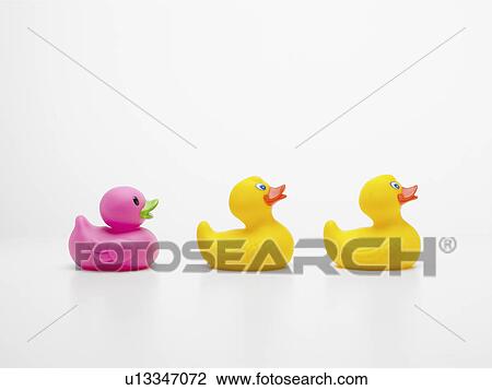 Stock Image - Three rubber ducks in row. Fotosearch