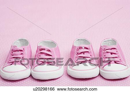 Stock Photograph - Two pairs of pink baby sneakers. Fotosearch