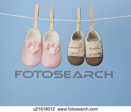 Stock Image - Two Pairs of Shoes on Clothes Line. Fotosearch