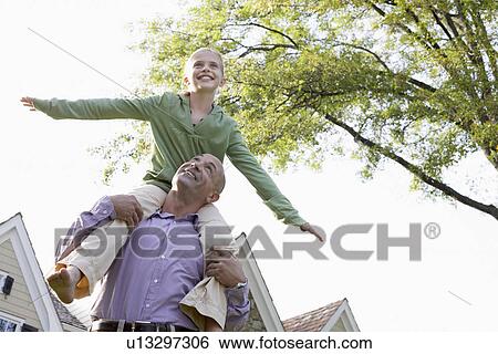 Father carrying daughter (10-11) on shoulders (low angle view), Chatham, New Jersey, USA View Large Photo Image Stock Photograph - Father carrying daughter (10-11) on shoulders (low angle view), Chatham, New Jersey, USA. Fotosearch