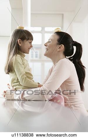 Mother and daughter balancing cakes on heads View Large Photo Image Stock Photo - Mother and daughter balancing cakes on heads. Fotosearch