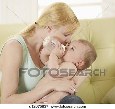 Mother Holding Baby Boy with Milk Bottle View Large Photo Image Stock Photo - Mother Holding Baby Boy with Milk Bottle. Fotosearch