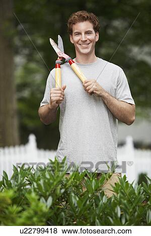 Stock Photo - Gardener holding hedge clippers. Fotosearch