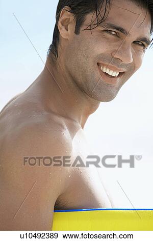 Portrait of young man with bodyboard View Large Photo Image Stock Photo - Portrait of young man with bodyboard. Fotosearch