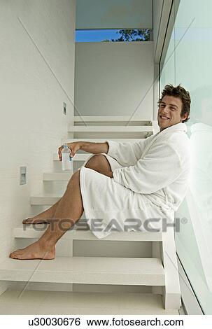 Young Man in Dressing Gown Drinking Water on Steps View Large Photo Image Stock Photograph - Young Man in Dressing Gown Drinking Water on Steps. Fotosearch