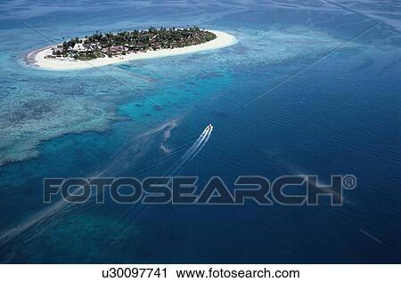 Stock Image - Motorboat Near Island. Fotosearch