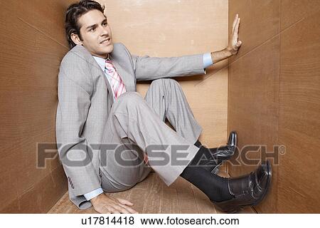 Stock Photo - Businessman in narrow box. Fotosearch