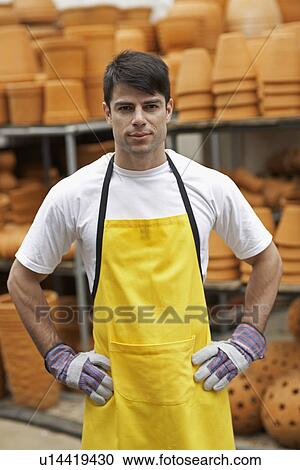 Stock Image - Male florist near flower pots. Fotosearch