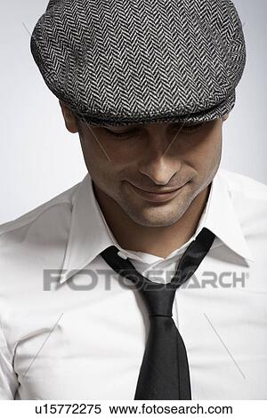 Stock Photography - Mid adult man wearing cap. Fotosearch
