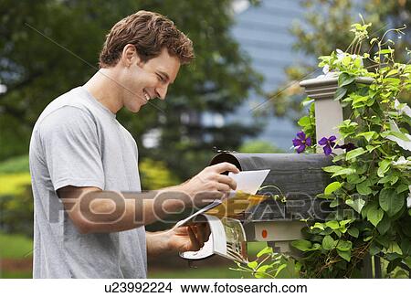 Picture - Young man collecting post. Fotosearch