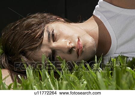 Picture - Young Man Lying on Grass. Fotosearch