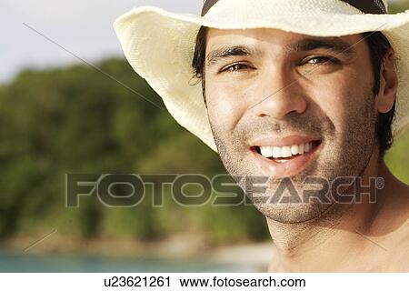Young man wearing straw hat View Large Photo Image Stock Image - Young man wearing straw hat. Fotosearch