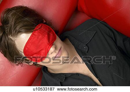 Stock Photo - Young Man with Sleep Mask. Fotosearch