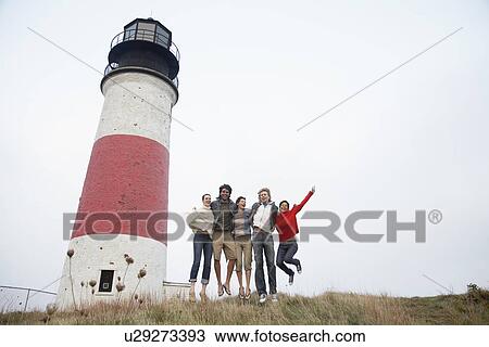 Five people jumping by lighthouse (low angle view) View Large Photo Image Stock Image - Five people jumping by lighthouse (low angle view). Fotosearch