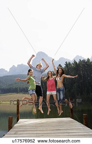 Four Teenagers Jumping on Jetty View Large Photo Image Stock Image - Four Teenagers Jumping on Jetty. Fotosearch