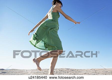 Young Woman in Dress Running on Sand View Large Photo Image Stock Image - Young Woman in Dress Running on Sand. Fotosearch