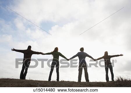 Four people holding hands in field (rear view, silhouette) View Large Photo Image Stock Image - Four people holding hands in field (rear view, silhouette). Fotosearch