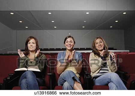 Three female students clapping in lecture theater View Large Photo Image Stock Photograph - Three female students clapping in lecture theater. Fotosearch