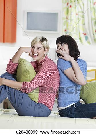 Two Young Women Whispering View Large Photo Image Stock Photo - Two Young Women Whispering. Fotosearch