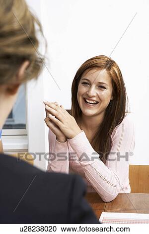 Stock Image - Young woman talking with a friend. Fotosearch