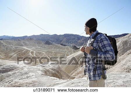 Stock Image - Male hiker in mountains, Death Valley, California, USA. Fotosearch