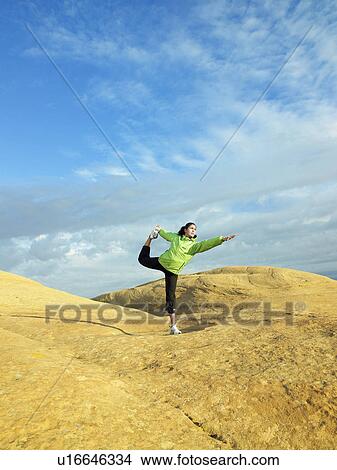 Woman doing yoga on rocky landscape View Large Photo Image Picture - Woman doing yoga on rocky landscape. Fotosearch
