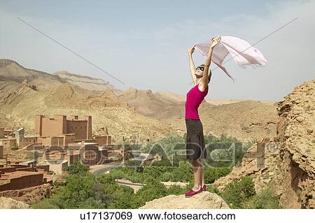 Woman Holding Up Scarf near Ruins View Large Photo Image Stock Photo - Woman Holding Up Scarf near Ruins. Fotosearch