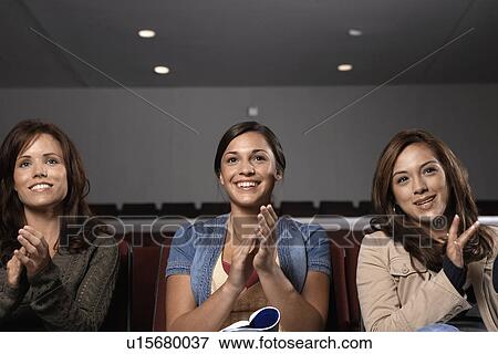 Stock Photo - Three female students clapping in lecture theater. Fotosearch