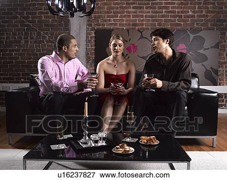 Stock Photo - Two men and woman having drinks. Fotosearch
