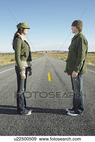 Woman and man standing face to face on highway View Large Photo Image Stock Photo - Woman and man standing face to face on highway. Fotosearch
