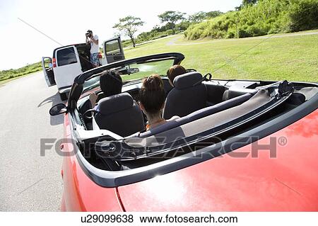 Man photographing young people in the car, Saipan, USA View Large Photo Image Stock Photo - Man photographing young people in the car, Saipan, USA . Fotosearch