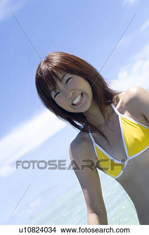 Portrait of a young woman smiling in the sea, Saipan, USA View Large Photo Image Picture - Portrait of a young woman smiling in the sea, Saipan, USA . Fotosearch