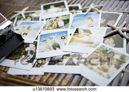 Stock Image - Stack of photographs of vacation, Saipan, USA . Fotosearch