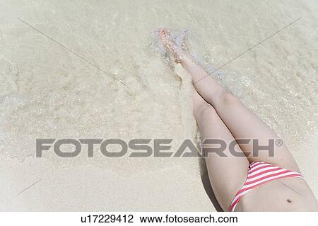 Woman lying on beach, Saipan, USA View Large Photo Image Stock Image - Woman lying on beach, Saipan, USA . Fotosearch