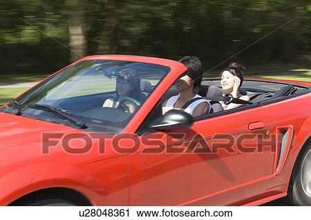 Young people in the car, man driving, panning, Saipan, USA View Large Photo Image Stock Image - Young people in the car, man driving, panning, Saipan, USA . Fotosearch