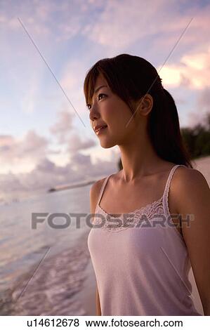 Young woman smiling on beach in the evening, differential focus, Saipan, USA View Large Photo Image Stock Photo - Young woman smiling on beach in the evening, differential focus, Saipan, USA . Fotosearch