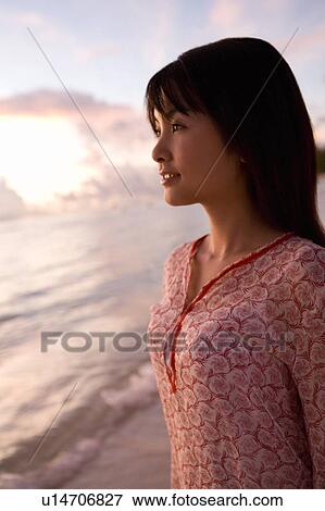 Young woman smiling on beach in the evening, Saipan, USA View Large Photo Image Stock Photo - Young woman smiling on beach in the evening, Saipan, USA . Fotosearch