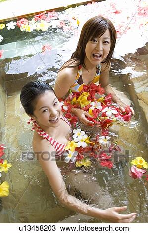 Young women in a bath full of flowers, Saipan View Large Photo Image Stock Image - Young women in a bath full of flowers, Saipan. Fotosearch