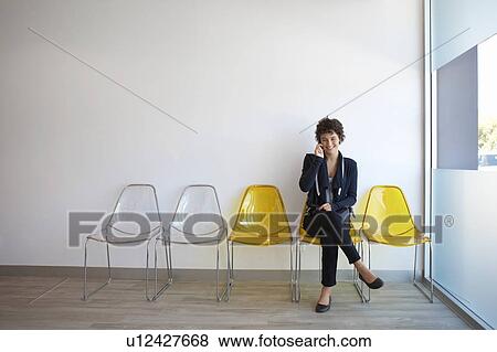 Teenage girl talking on phone in lobby View Large Photo Image Stock Photo - Teenage girl talking on phone in lobby. Fotosearch
